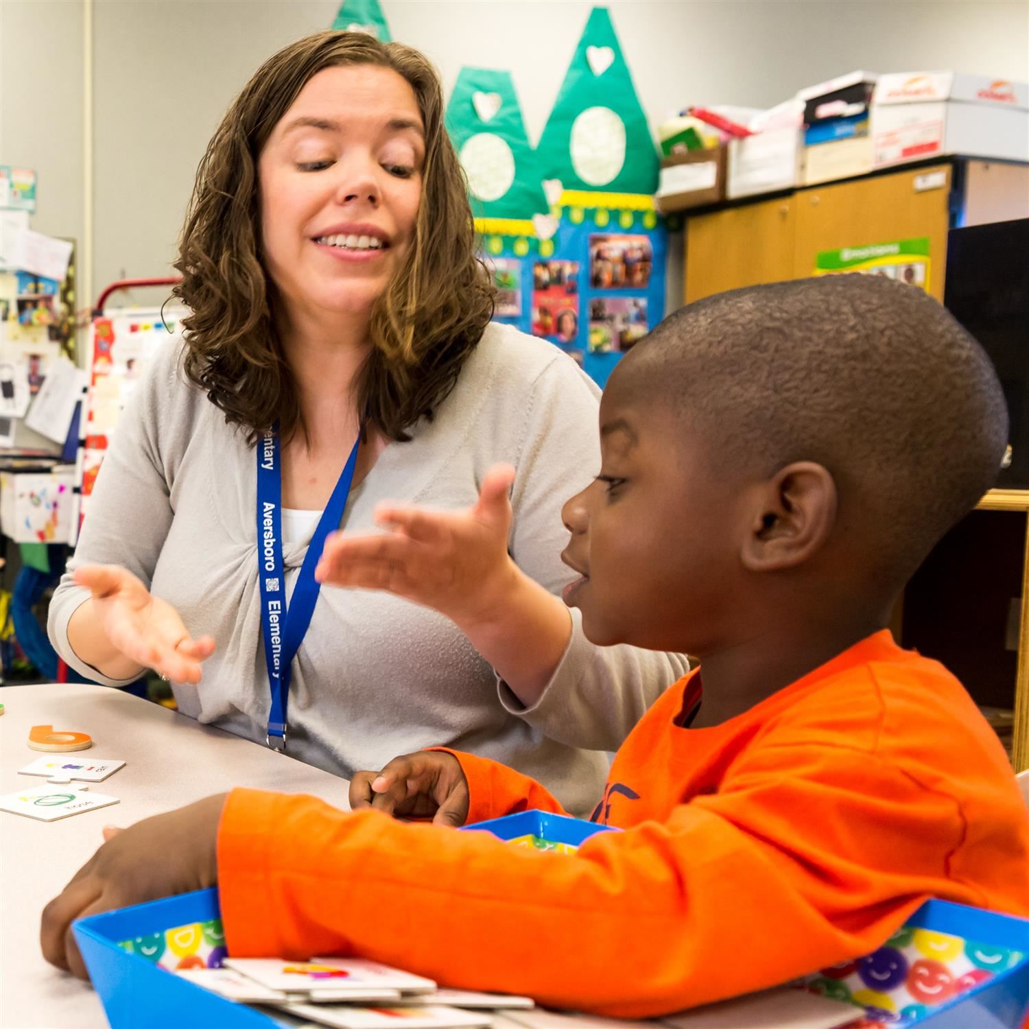  teacher with student at table